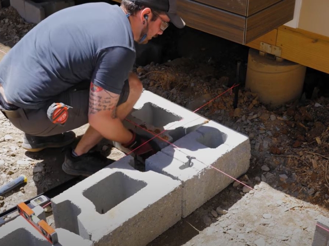 CornerStone retaining wall base course outside corner installation by Crafted Workshop