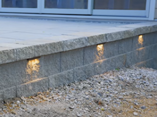 Crafted Workshop - Finished raised patio with CornerStone Retaining Wall and Under Cap Lighting