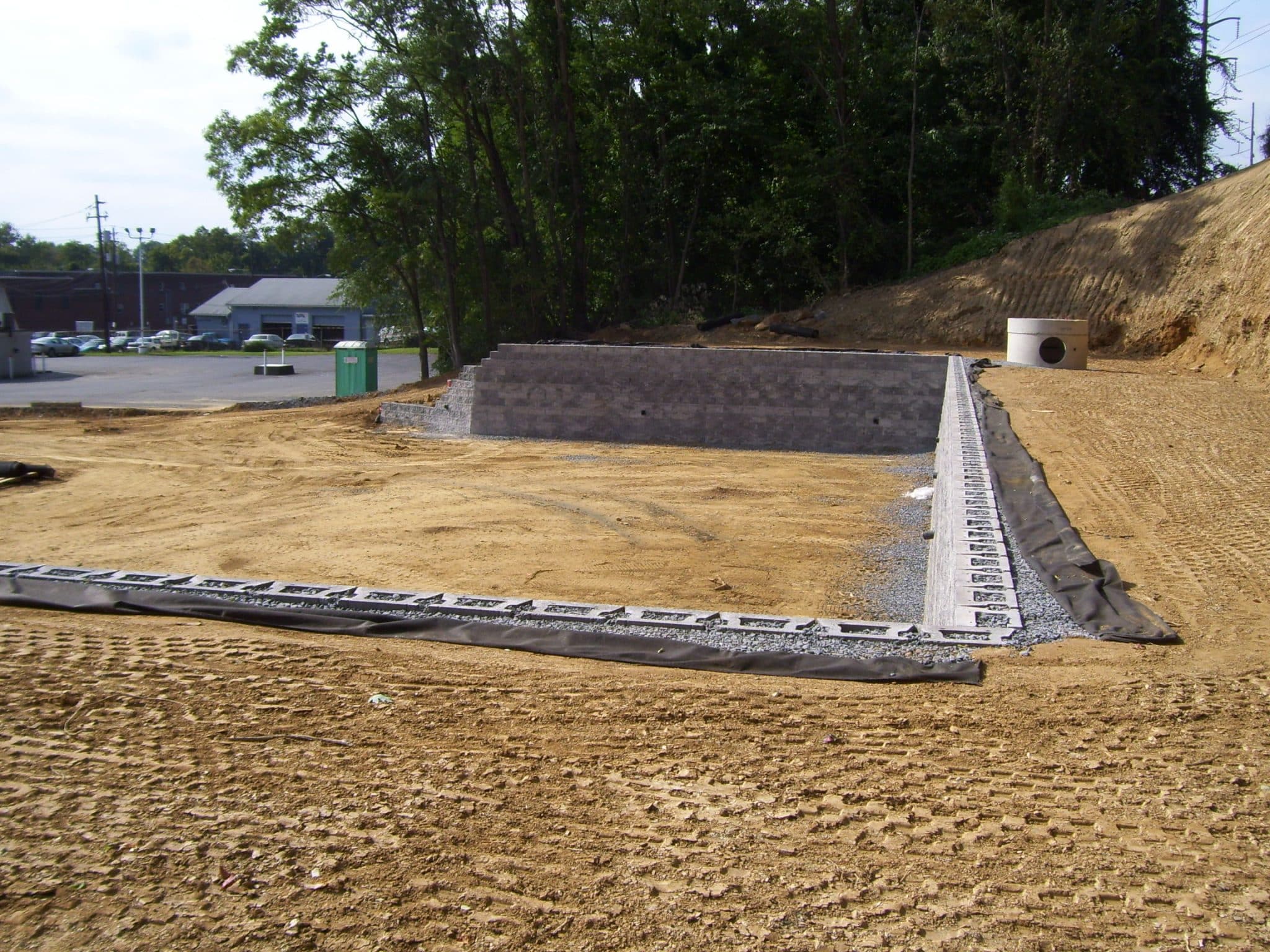 Commercial CornerStone retaining wall with gravel backfill and filter fabric.