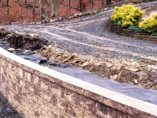 Filter fabric covers drainage gravel behind CornerStone 100 retaining wall.