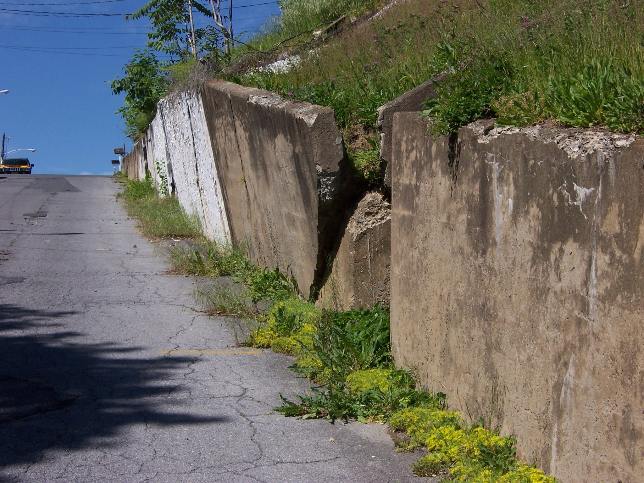 An overturning cast-in-place concrete retaining wall.