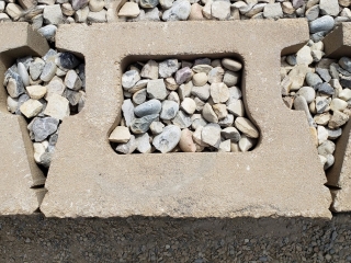Compacted drainage gravel within and behind CornerStone 100 blocks. Compacted drainage gravel within and behind CornerStone 100 blocks.
