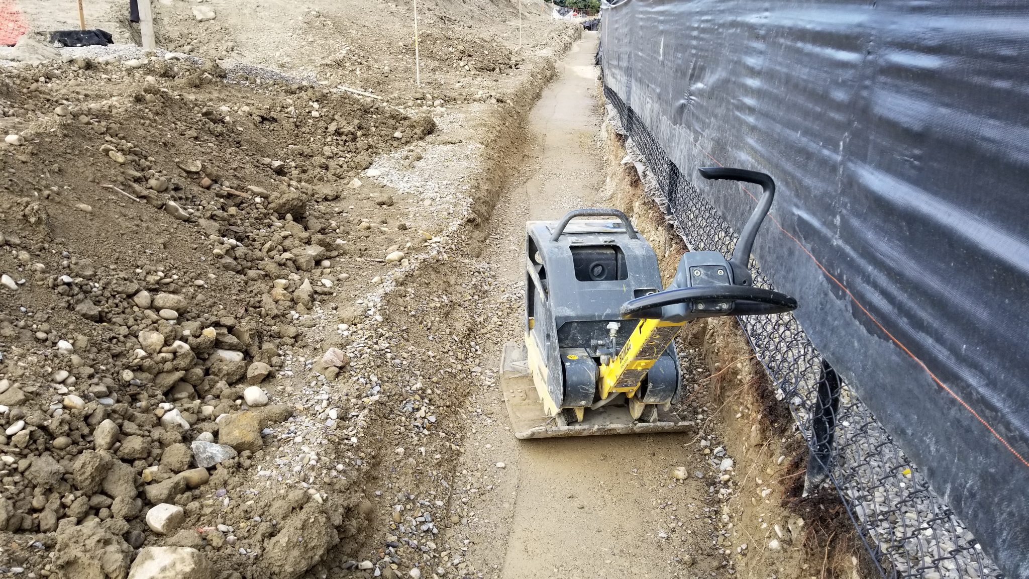 Retaining wall base pad preparation includes vital compaction.