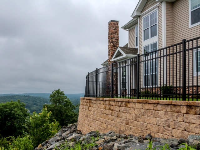 StoneLedge retaining wall blocks create yard space atop hill.