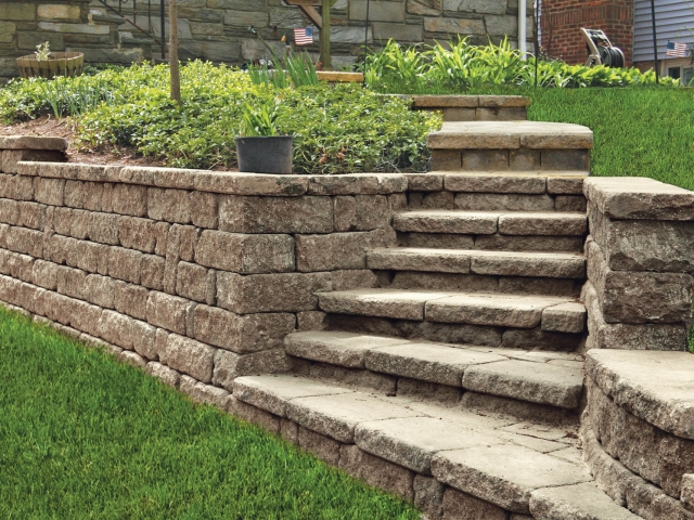 StoneLedge retaining wall in backyard creates planters and stairs.