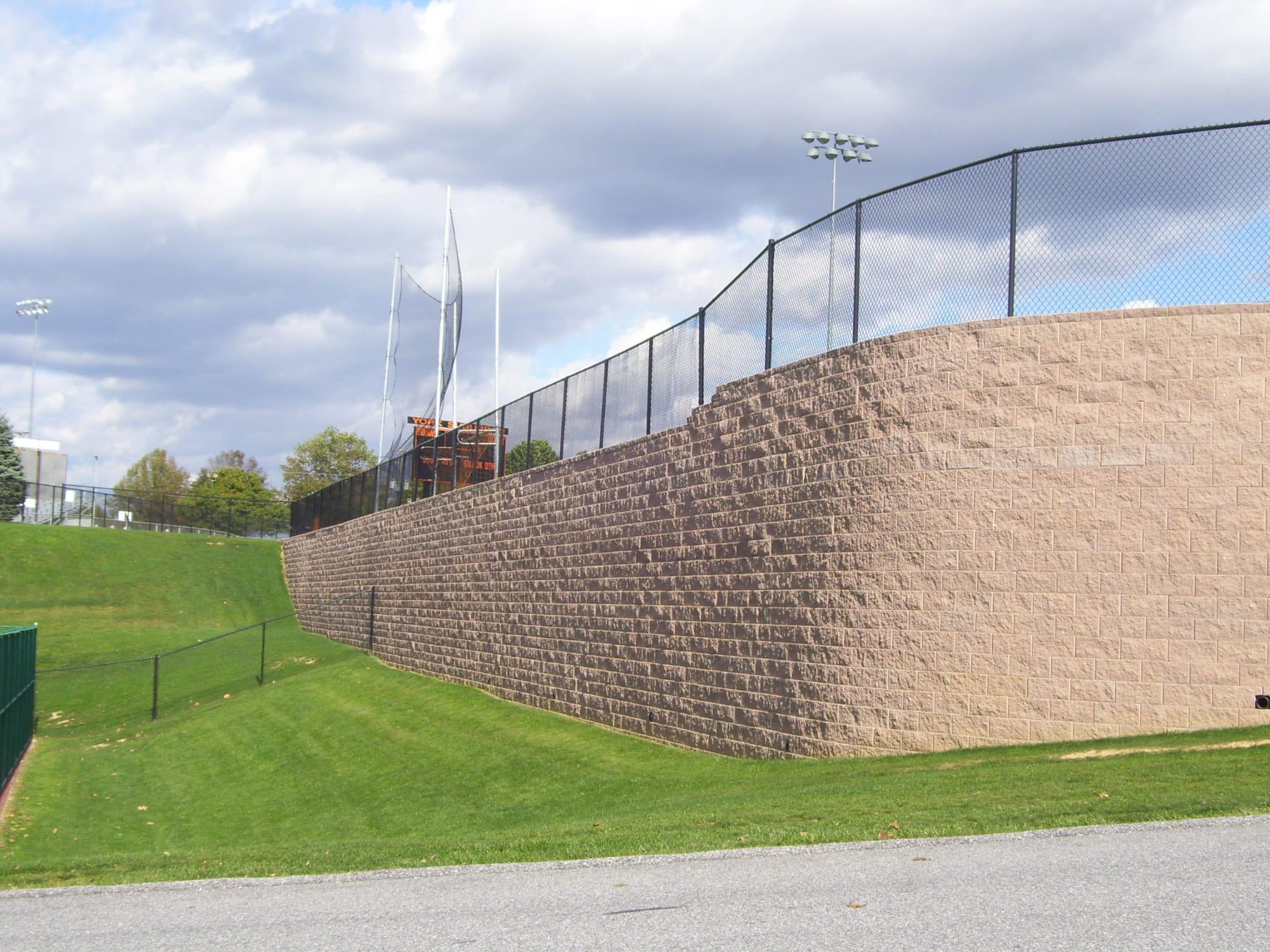 Tall concrete block retaining wall for athletic fields.